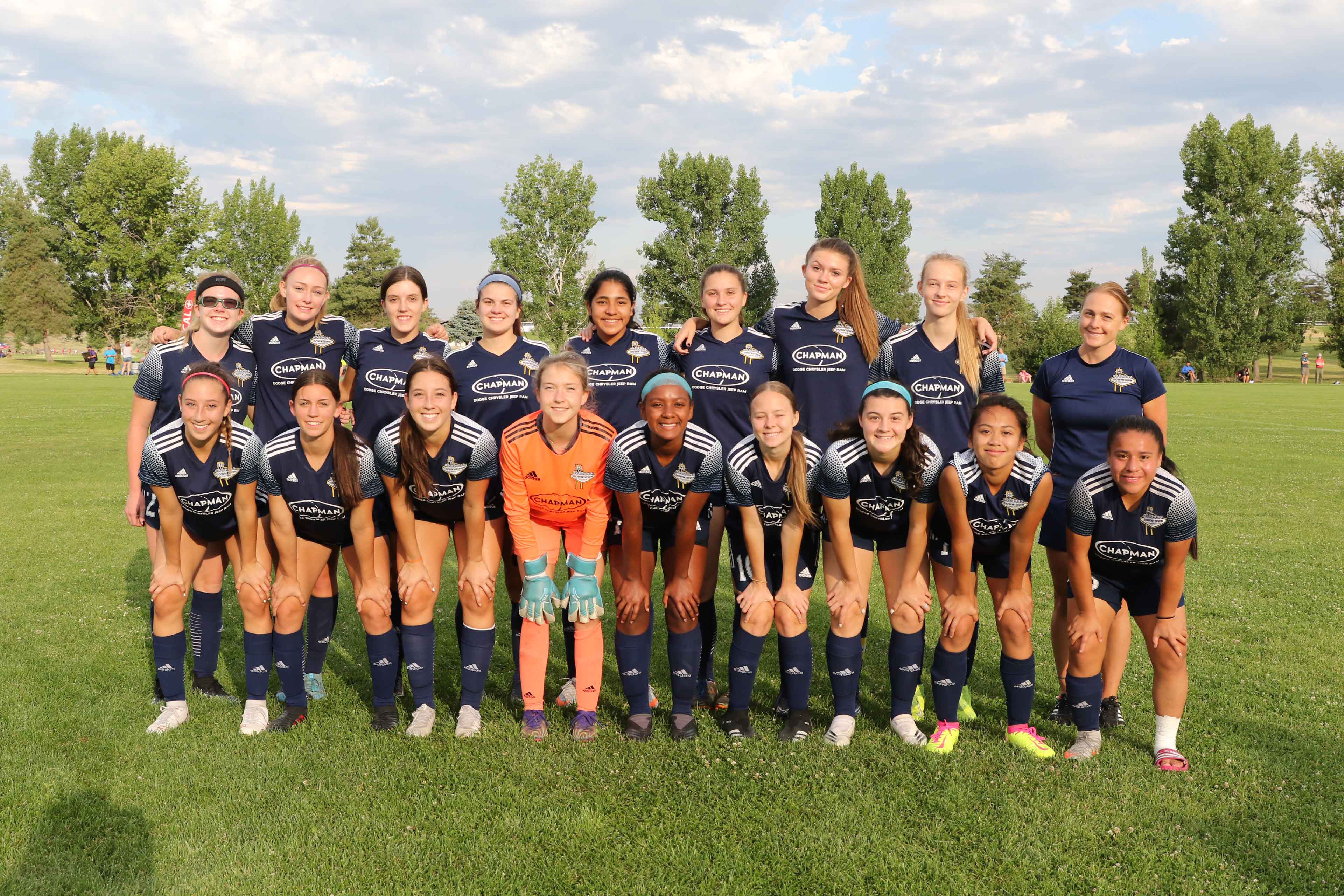 female soccer team posing for a photo before a match