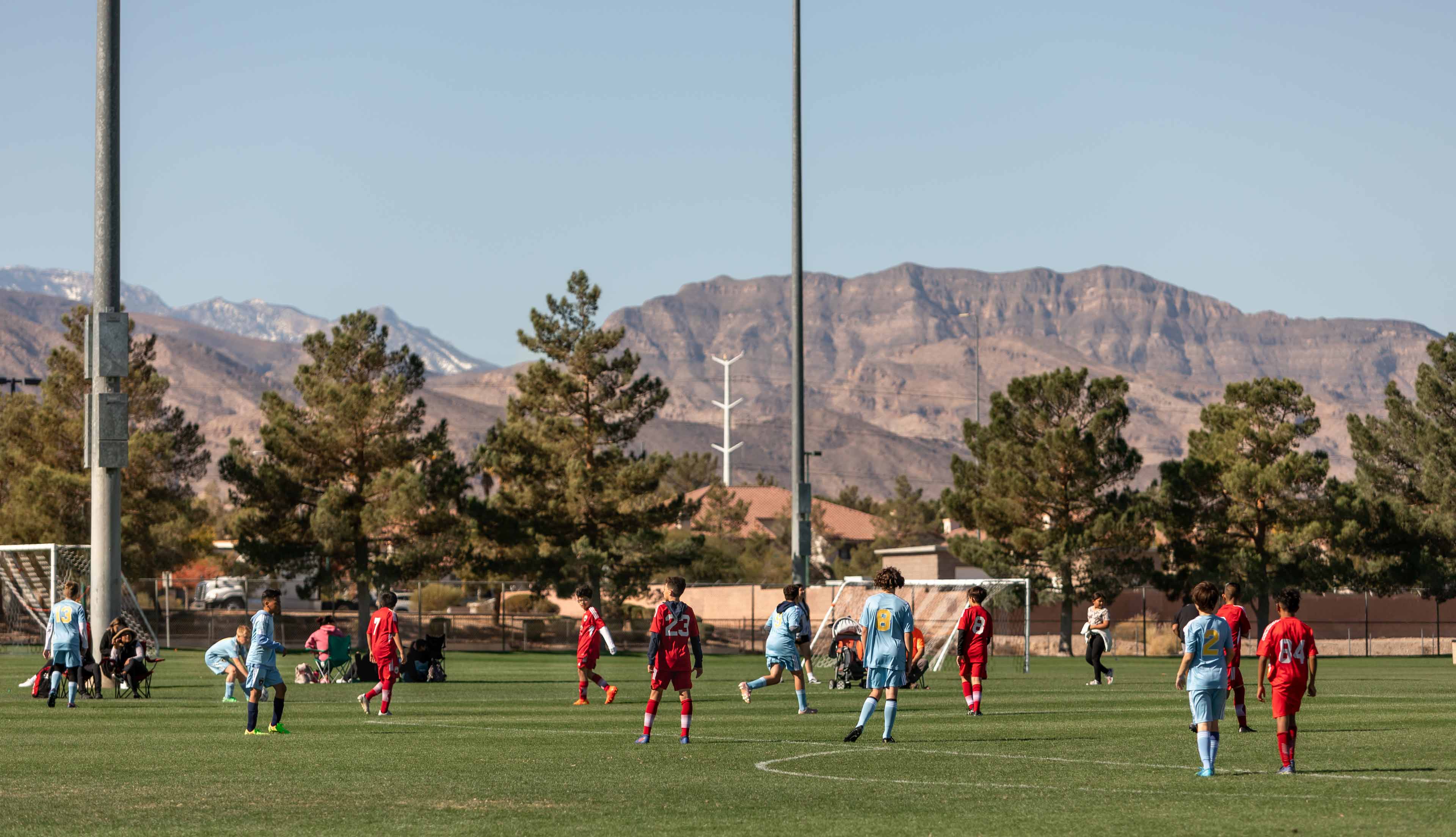 youth soccer game players giving it all