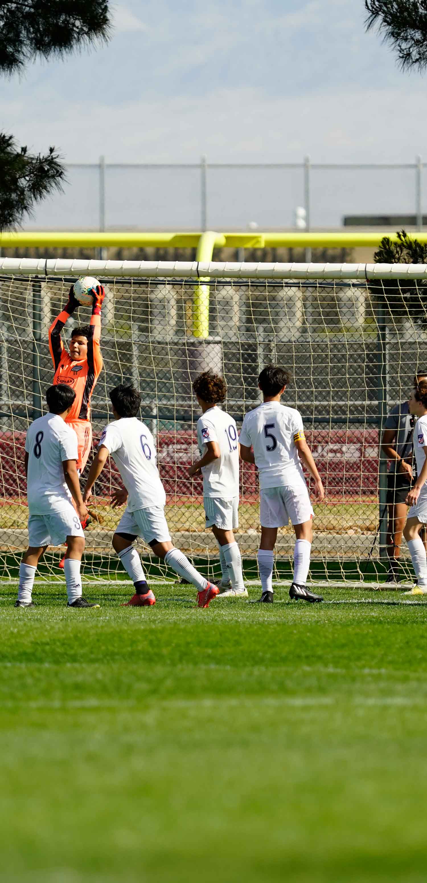goalie catching the ball coming from a corner kick
